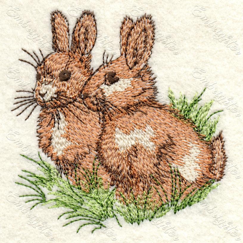 Machine embroidery design for Easter. Cute bunnies sitting on the grass, fresh spring pattern.
